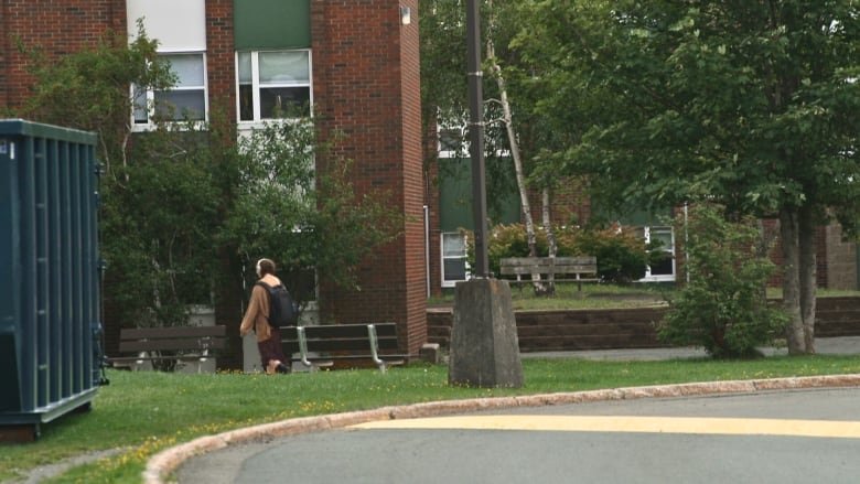 Person walks between apartment buildings