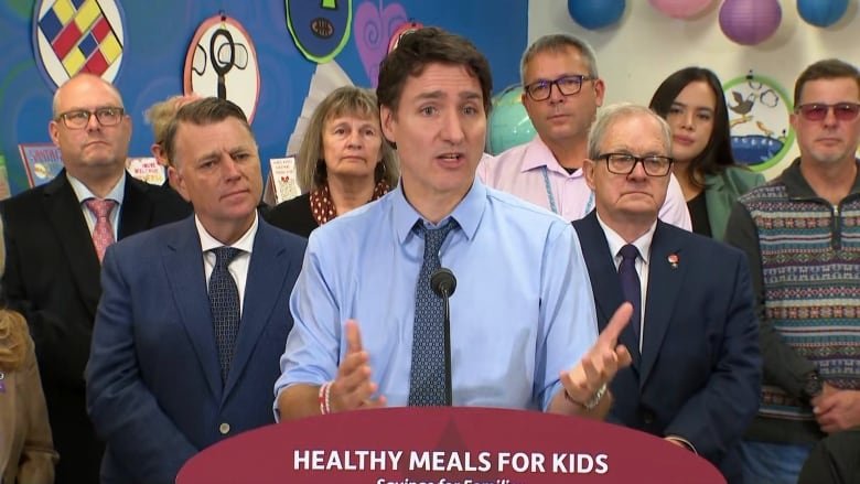 Prime Minister Justin Trudeau is flanked by Prince Edward Island Premier Dennis King, left, and Cardigan MP Lawrence MacAulay at Mount Stewart Consolidated school on Friday, Nov. 29, 2024.