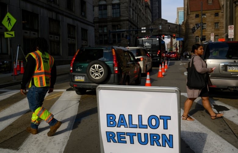 Public Works employees guide people to the county ballot return outside the County Office building in Pittsburgh.