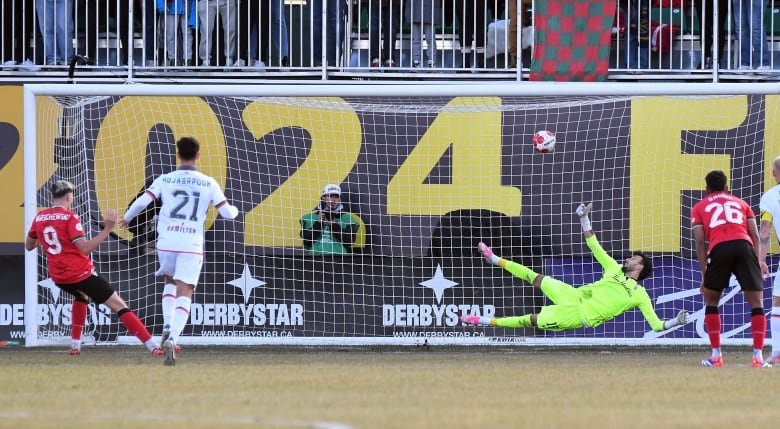 Cavalry FC's male scores a penalty kick against Forge FC male keeper during first half soccer action in the Canadian Premier League Final in Calgary on Saturday, November 9, 2024.