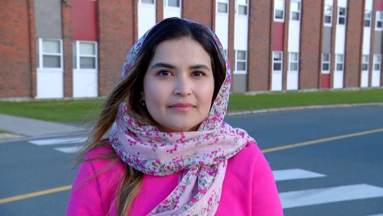 Woman with a pink floral head scarf.